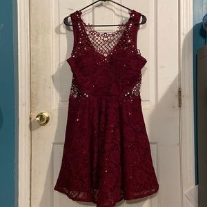 This is a burgundy/wine colored lace dress with side cutouts w/ semi-puffy skirt